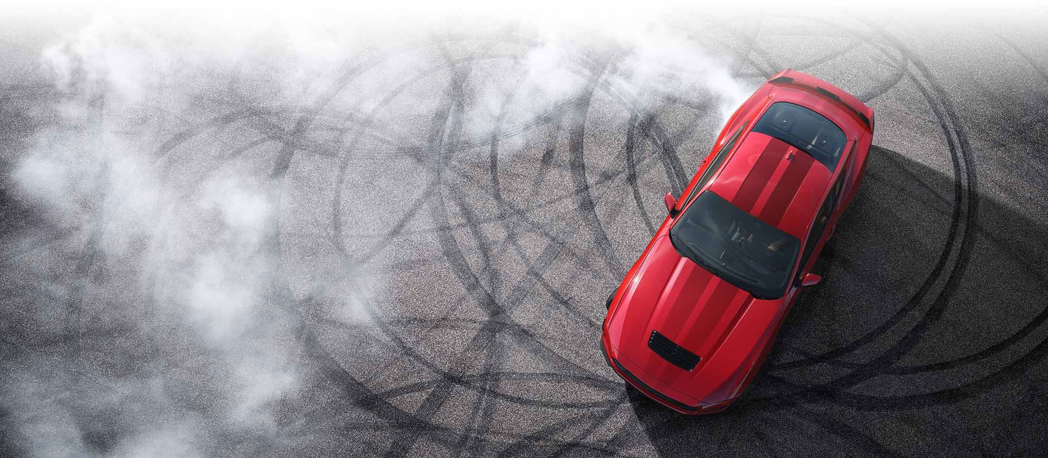 Overhead view of a 2024 Ford Mustang® model with tire tracks on pavement | Austin Ford in Austin MN