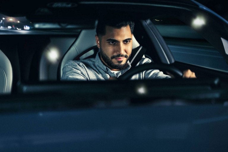 Person sitting in the driver’s seat of a parked 2024 Ford Mustang® coupe | Austin Ford in Austin MN